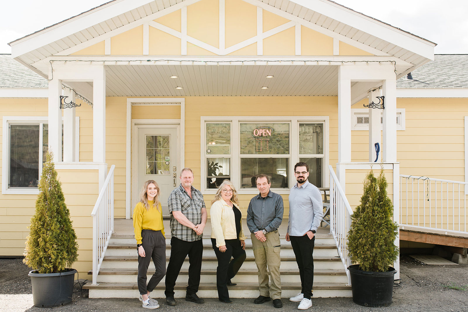 the countryside manufactured homes team stands on the steps of their office showhome in kamloops bc
