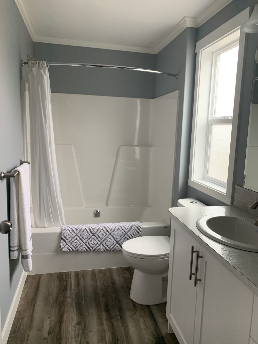 first bathroom in the kelowna showhome built by countryside manufactured homes in salmon arm bc tub surround and single sink and toilet
