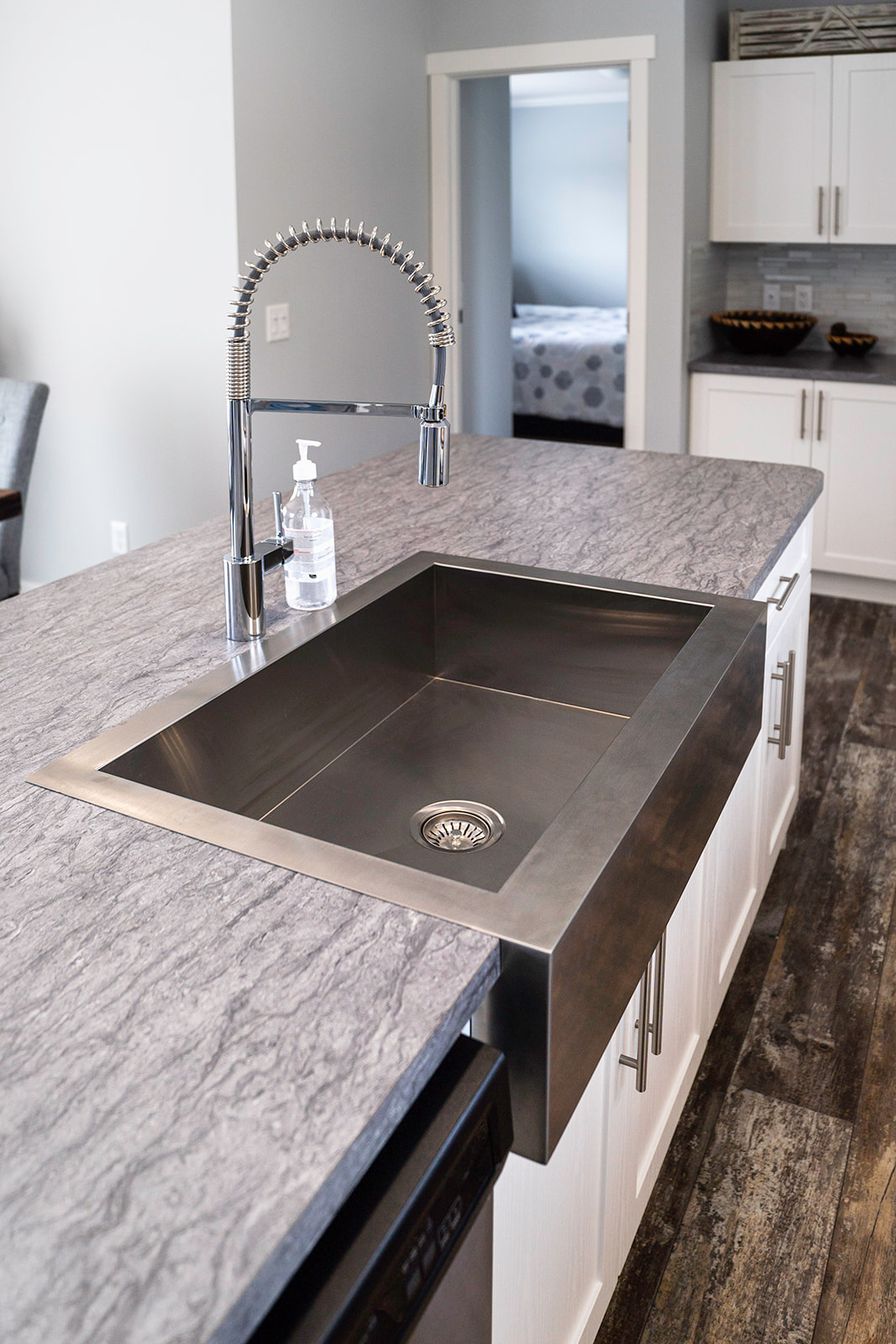 island sink looking into bedroom off kitchen in a countryside manufactured showhome