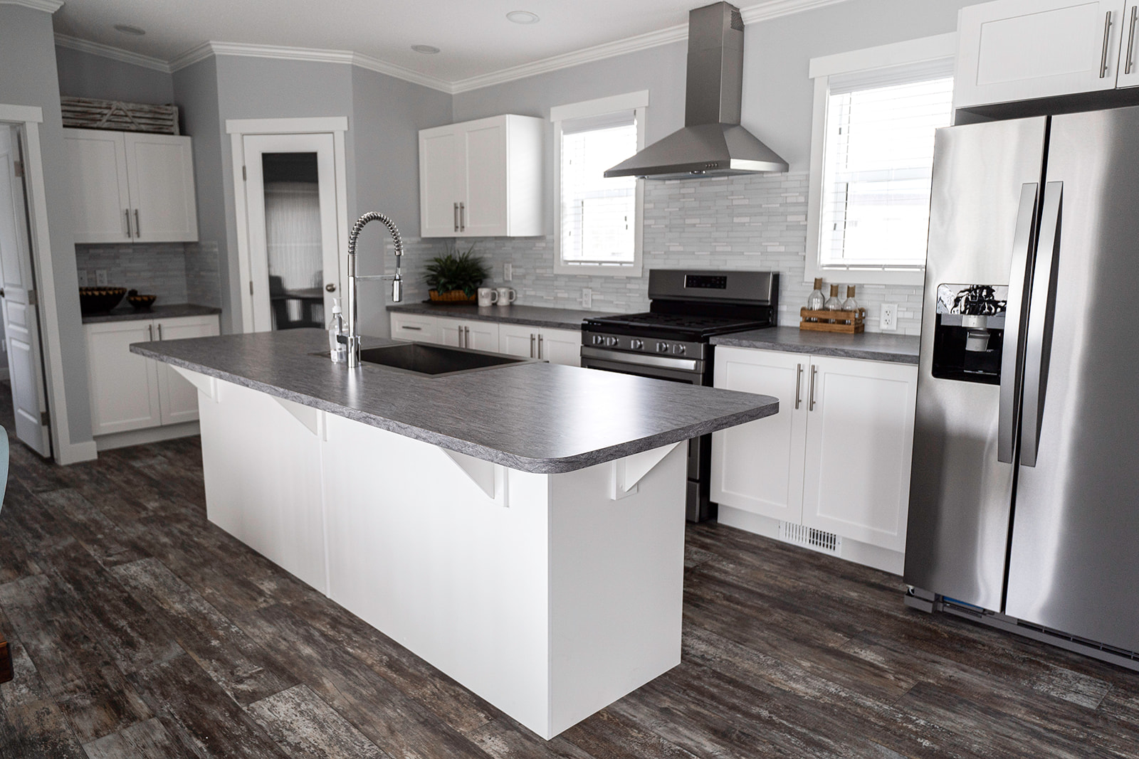 gorgeous open concept kitchen with eating bar in the ashford showhome by countryside