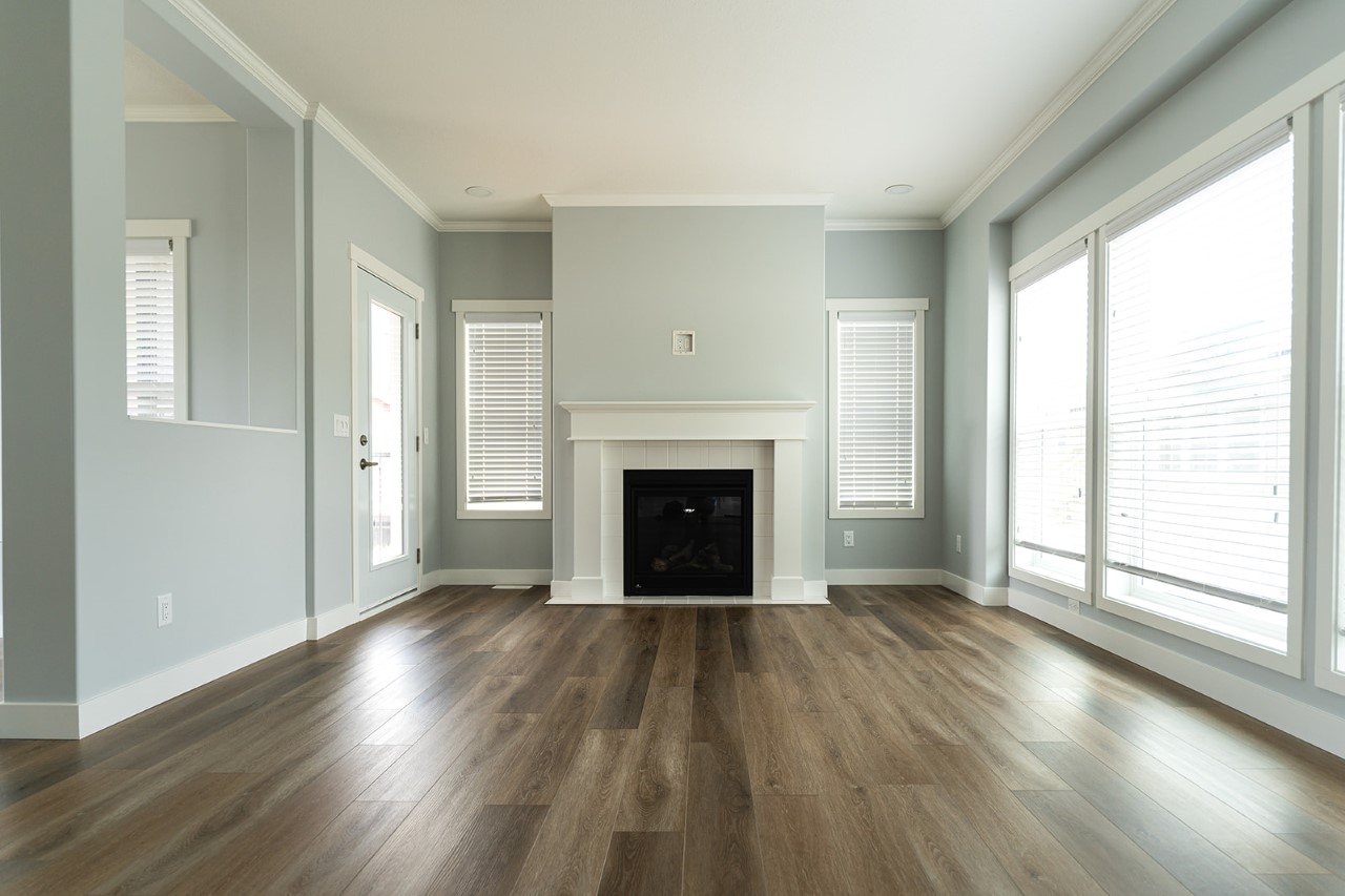 long view of the living room with large windows and fireplace in one of the modular homes built by countryside manufactured homes in salmon arm