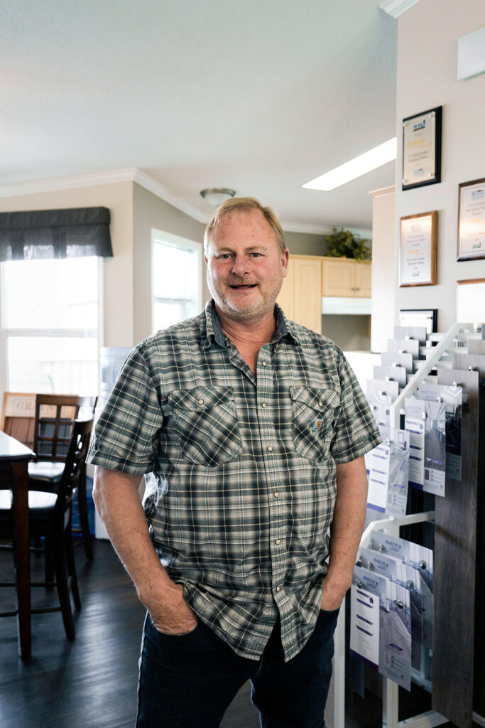 Countryside Manufactured Homes Owner and Operator Frank Ambler smiles at the camera in one of their BC manufactured homes locations