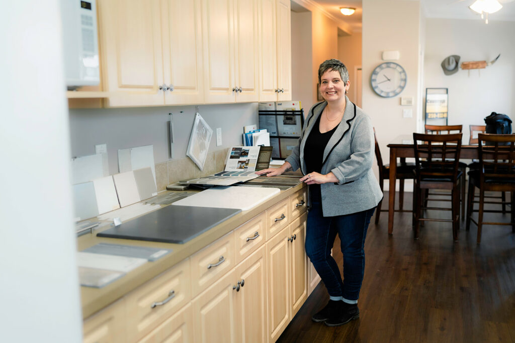 Countryside team member Rebekka in a grey blazer smiling and excited to help a buyer find their new manufactured or modular home